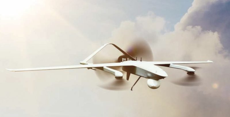 Hybrid VTOL surveillance UAV in flight above the clouds